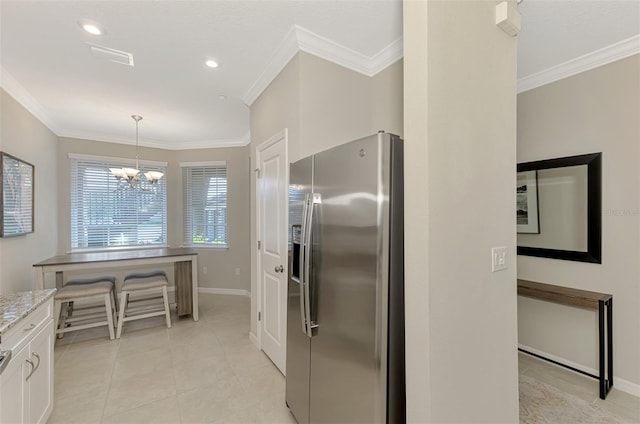 kitchen featuring white cabinets, crown molding, stainless steel refrigerator with ice dispenser, light stone counters, and a chandelier