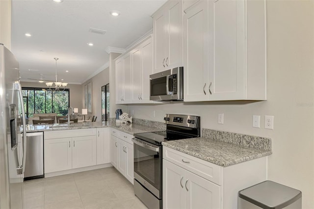 kitchen with sink, stainless steel appliances, an inviting chandelier, white cabinets, and ornamental molding