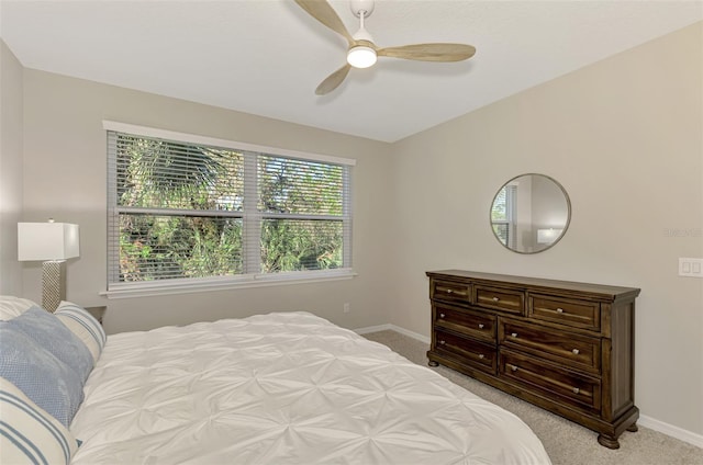 carpeted bedroom with multiple windows and ceiling fan