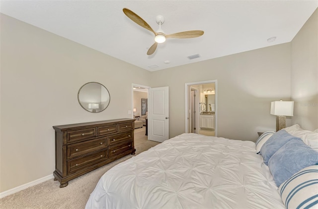 carpeted bedroom with ceiling fan and ensuite bath