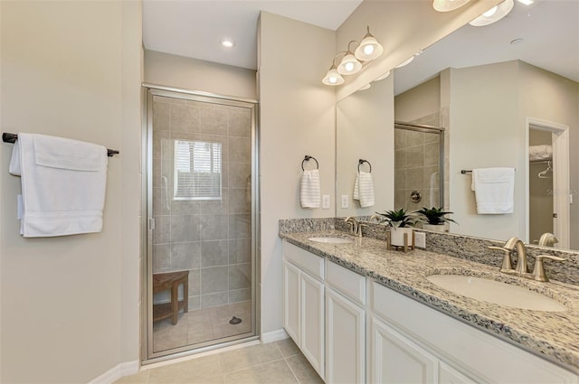 bathroom with tile patterned flooring, vanity, and walk in shower