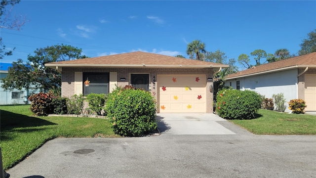 view of front facade with a front yard and a garage