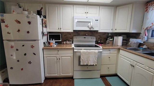 kitchen featuring dark hardwood / wood-style flooring, backsplash, white appliances, sink, and white cabinetry