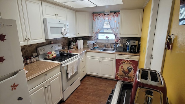 kitchen with sink, tasteful backsplash, dark hardwood / wood-style floors, white appliances, and white cabinets