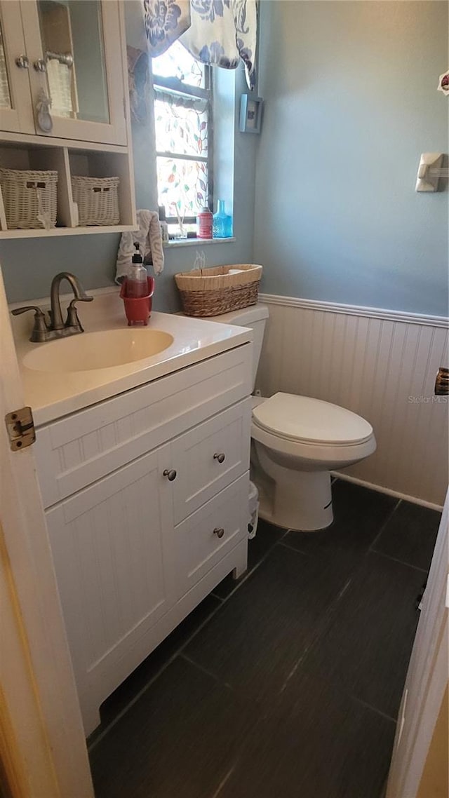 bathroom with vanity, hardwood / wood-style flooring, and toilet