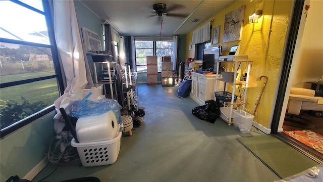 interior space with ceiling fan, concrete flooring, and a wall mounted air conditioner