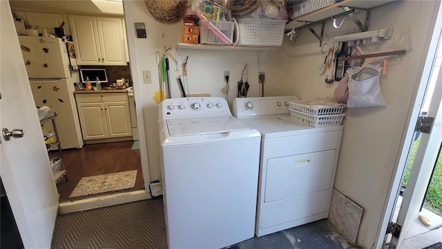 washroom featuring washer and dryer and dark wood-type flooring