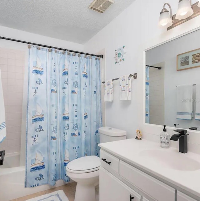 full bathroom with tile patterned floors, vanity, a textured ceiling, and toilet