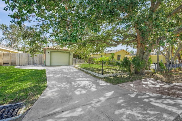 view of front of property featuring a front yard and a garage