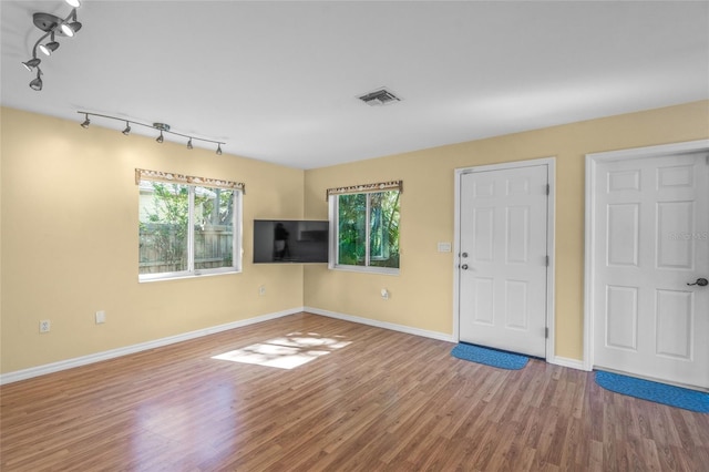 interior space featuring hardwood / wood-style floors and track lighting