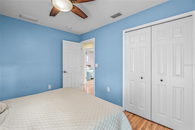 bedroom featuring ceiling fan, a closet, and light wood-type flooring