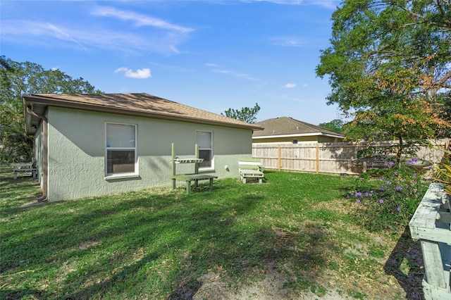 rear view of property with a lawn