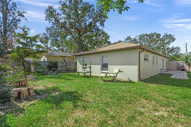 rear view of house with a yard