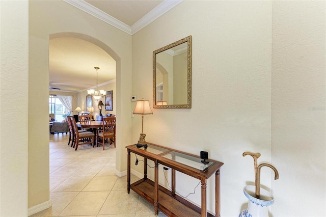 hall with crown molding, light tile patterned floors, and an inviting chandelier