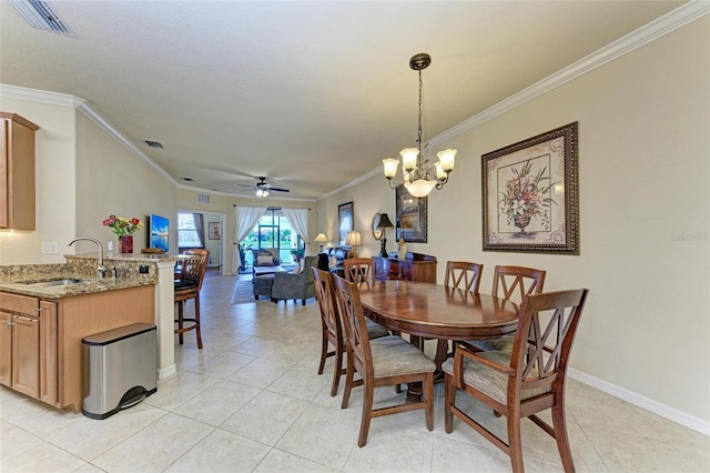 dining space featuring light tile patterned flooring, ceiling fan with notable chandelier, crown molding, and sink