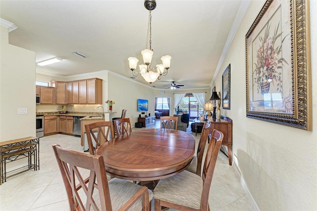 tiled dining room with ceiling fan with notable chandelier, ornamental molding, and sink