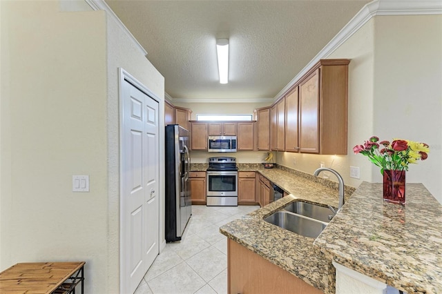 kitchen with sink, stainless steel appliances, a textured ceiling, and ornamental molding