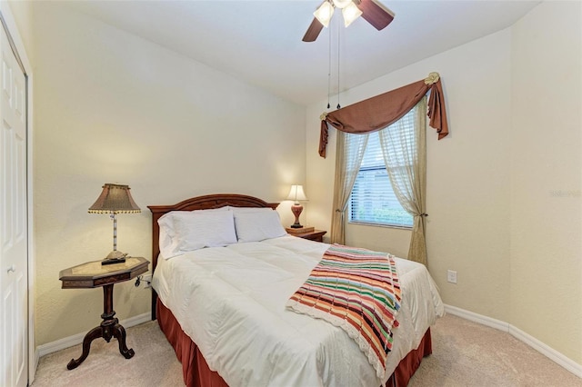 bedroom featuring ceiling fan, a closet, and light colored carpet