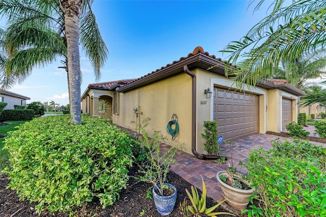 view of side of home with a garage