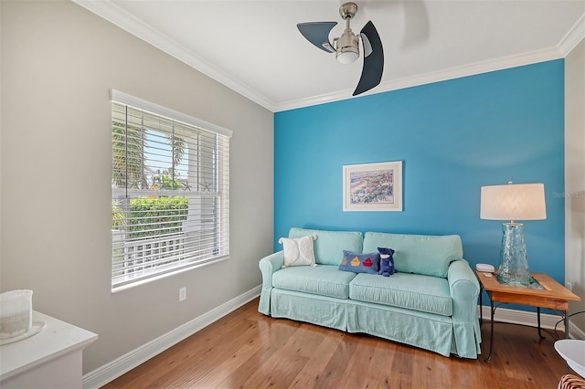 living area with hardwood / wood-style flooring, ceiling fan, and ornamental molding