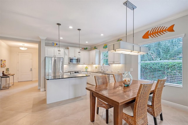 dining room featuring a healthy amount of sunlight, light tile patterned floors, and sink