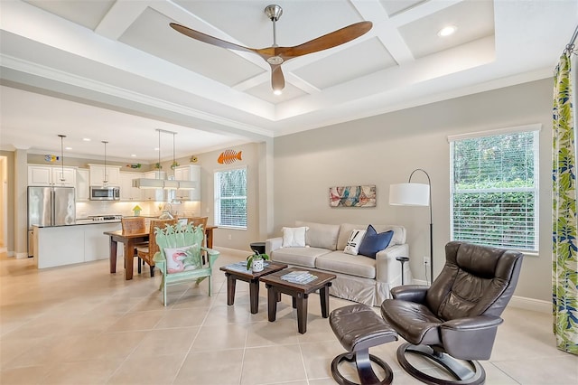 living room with light tile patterned floors, a healthy amount of sunlight, and coffered ceiling