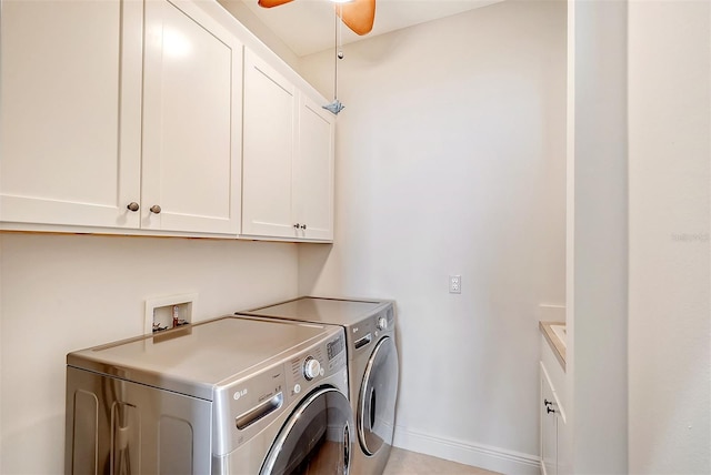 laundry room featuring cabinets, washer and clothes dryer, and ceiling fan