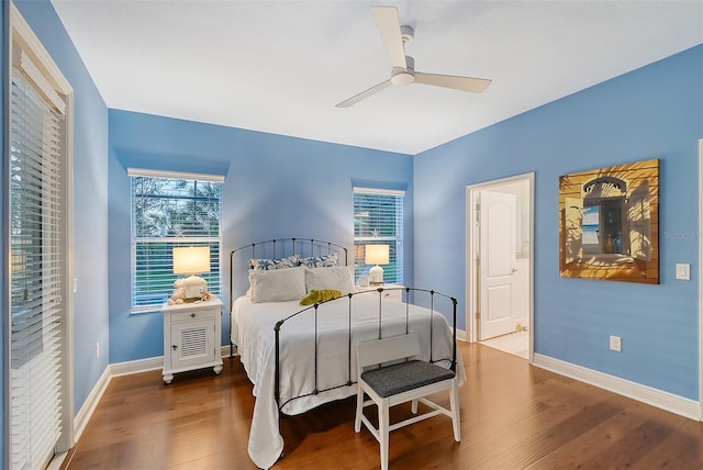 bedroom with hardwood / wood-style floors, ensuite bath, and ceiling fan