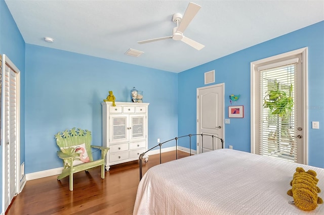 bedroom featuring access to outside, ceiling fan, and dark hardwood / wood-style floors