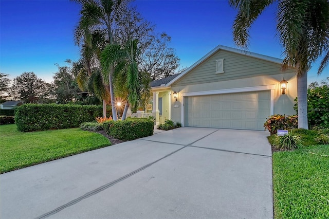 ranch-style home featuring a yard and a garage