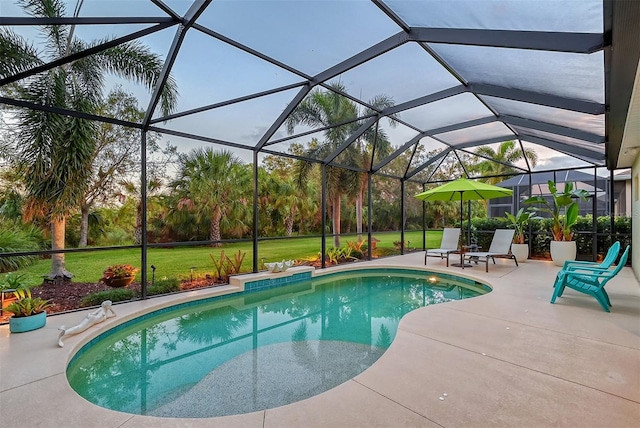 view of swimming pool featuring a lanai, a yard, and a patio