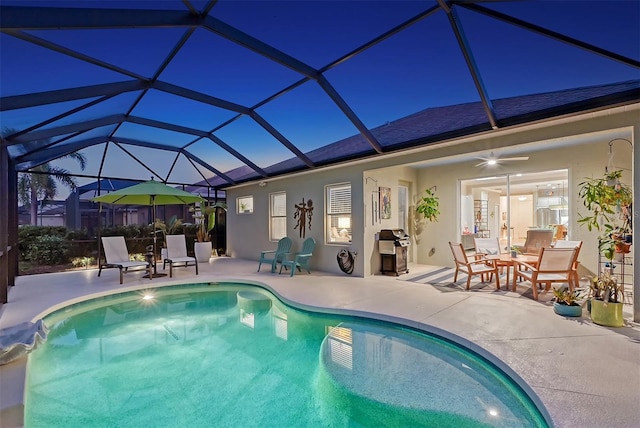 view of pool featuring glass enclosure, ceiling fan, a patio, and grilling area