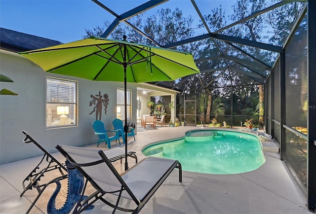 view of swimming pool featuring glass enclosure, ceiling fan, and a patio