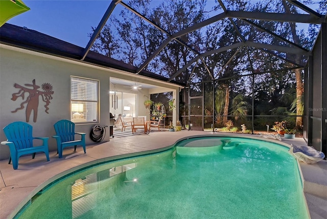 view of swimming pool with a patio, ceiling fan, and a lanai