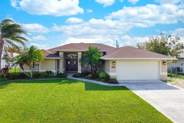 view of front of house with a front lawn and a garage