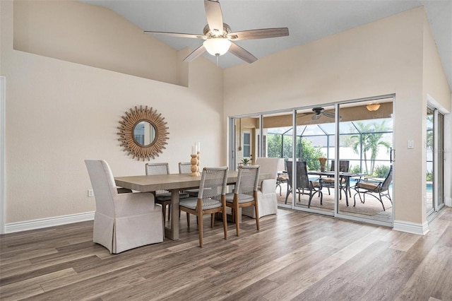 dining space with lofted ceiling, ceiling fan, and wood-type flooring