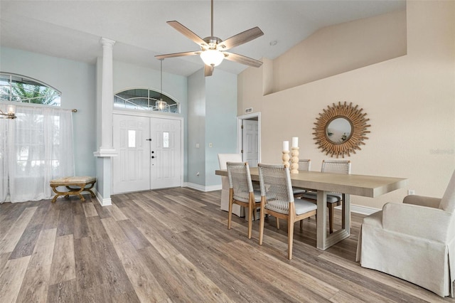 dining area with ceiling fan, vaulted ceiling, and hardwood / wood-style flooring