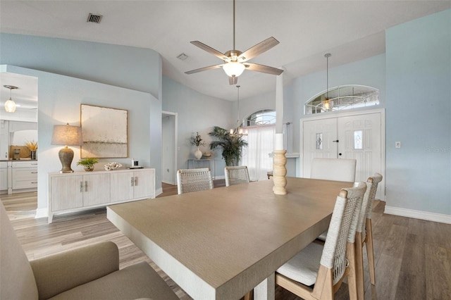 dining space featuring ceiling fan, high vaulted ceiling, and light hardwood / wood-style floors