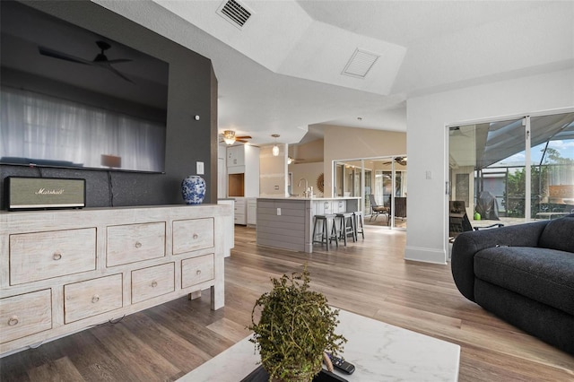 living room featuring light hardwood / wood-style flooring and lofted ceiling