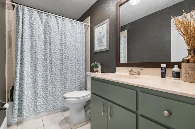 bathroom with vanity, a textured ceiling, tile patterned floors, and toilet