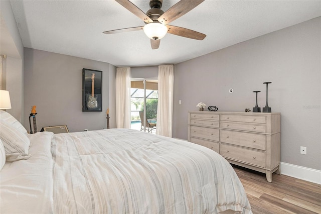 bedroom featuring access to outside, ceiling fan, and light hardwood / wood-style floors