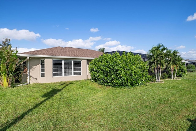 rear view of house featuring a lawn