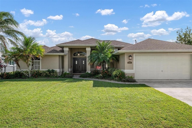 view of front of house featuring a front lawn and a garage