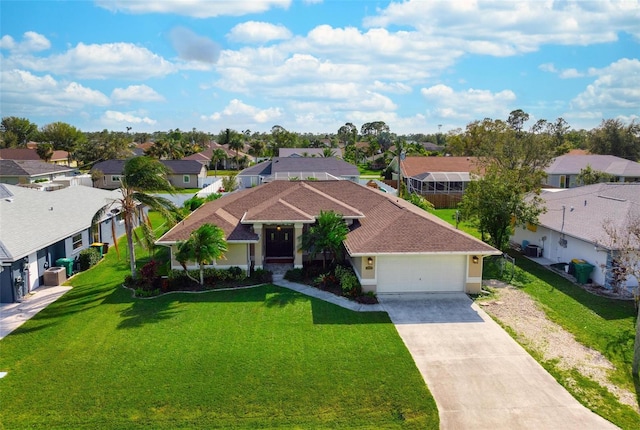 view of front of property featuring a front yard and a garage