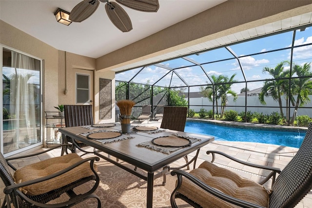 view of swimming pool with pool water feature, a patio, ceiling fan, and a lanai