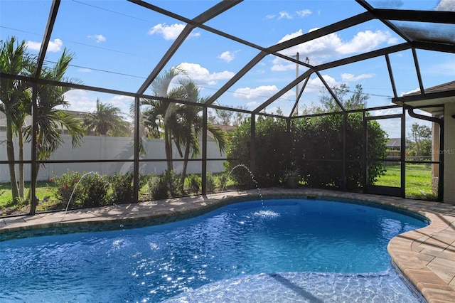 view of pool with pool water feature and a lanai