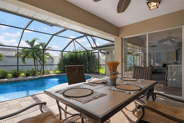 exterior space with a fenced in pool, glass enclosure, pool water feature, and ceiling fan