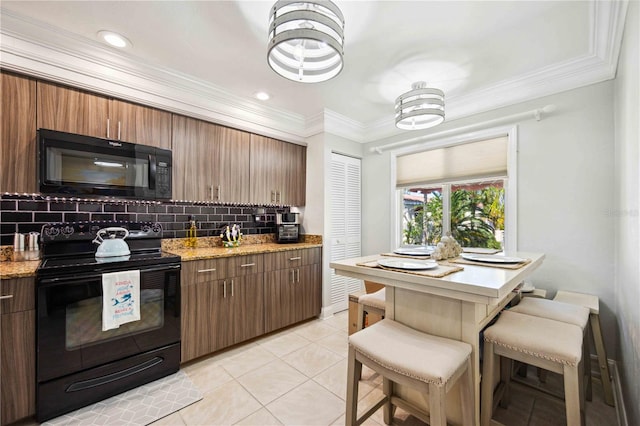 kitchen with a breakfast bar, backsplash, black appliances, light stone countertops, and light tile patterned floors