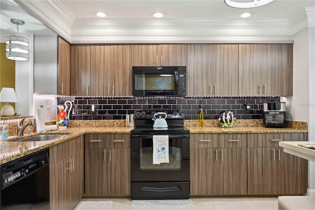 kitchen featuring sink, tasteful backsplash, light stone counters, and black appliances