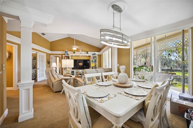 dining area featuring ornate columns, crown molding, light colored carpet, vaulted ceiling, and ceiling fan with notable chandelier